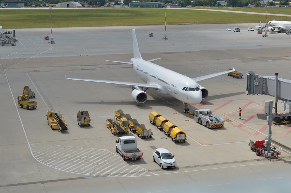 Baggage trucks and airplane on tarmac