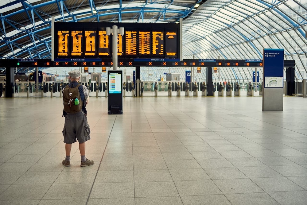 Person looking at a departures board at the airport